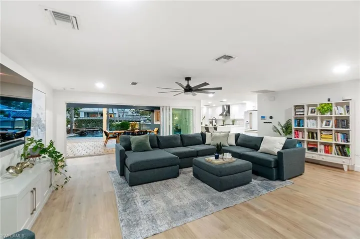 Living room featuring ceiling fan and light wood-type flooring