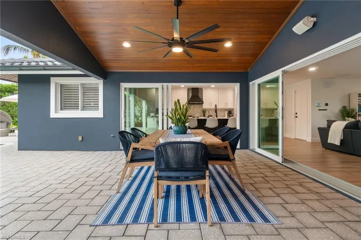 View of patio highlighted by 2 sets of pocketing impact slider door walls.
