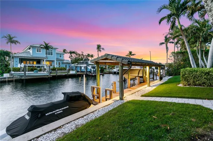 Dock area featuring a yard and a water view