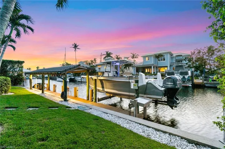 Dock area featuring a yard and a water view