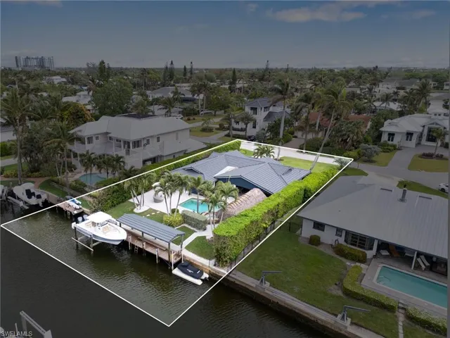 Bird's eye arial view of inter coastal waterway estate property with boat and jet ski docks.