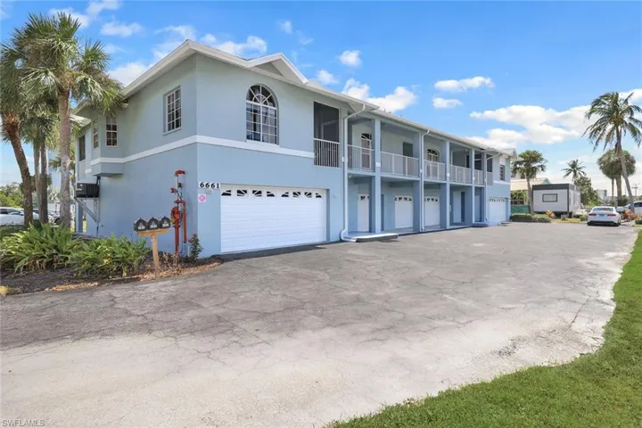 View of property with a garage and a balcony
