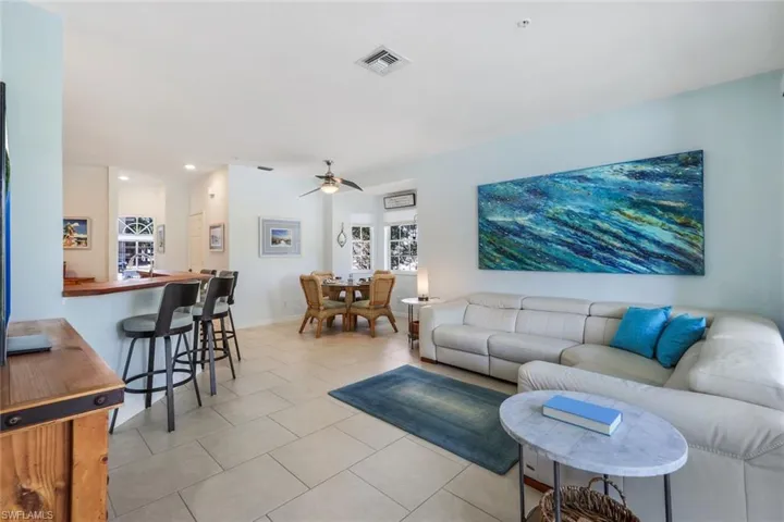 Tiled living room featuring ceiling fan