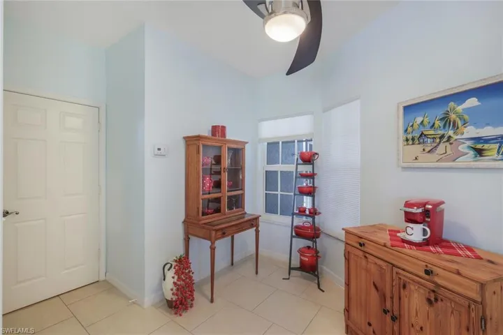 Tiled home office featuring ceiling fan