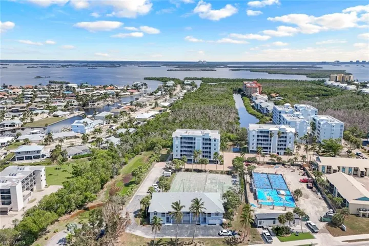 Birds eye view of property with a water view