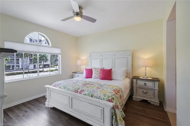 Bedroom with dark hardwood / wood-style flooring and ceiling fan