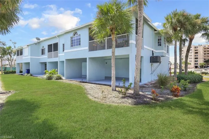 Back of property featuring a patio and a yard