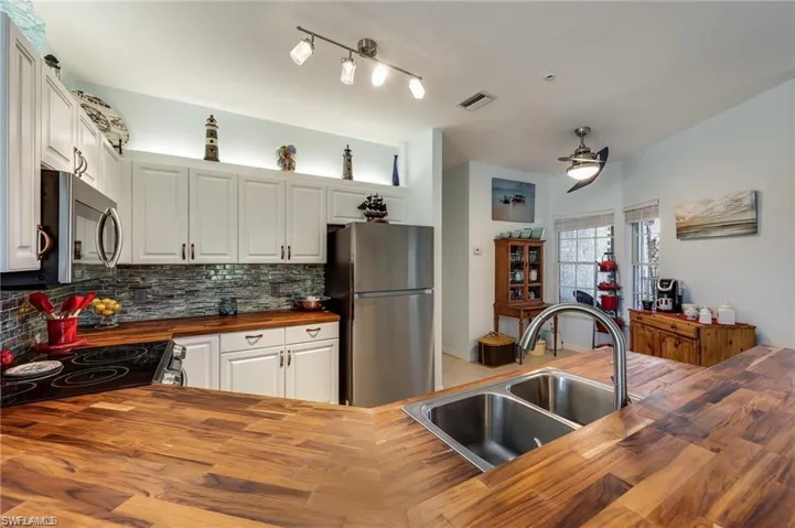 Kitchen featuring sink, stainless steel appliances, and wooden counters