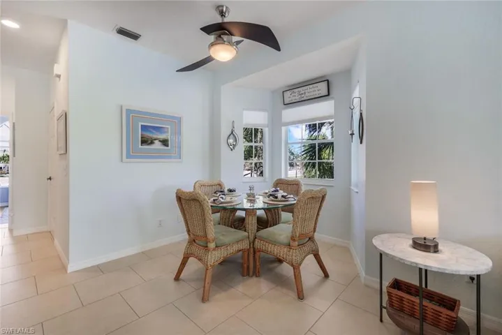 Tiled dining room featuring ceiling fan