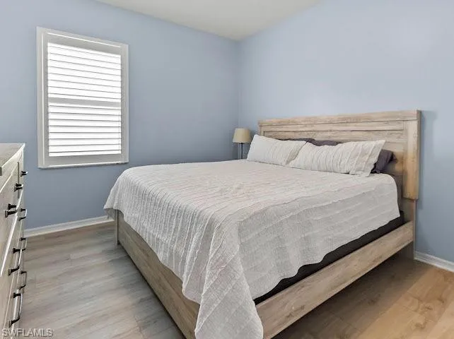 Bedroom with baseboards and light wood-style floors