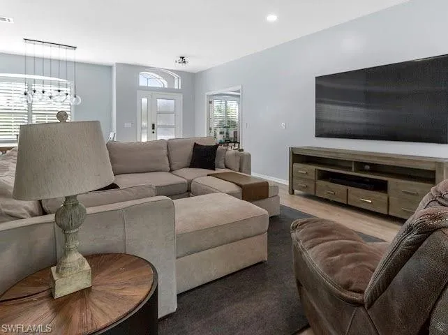 Living area with recessed lighting and wood finished floors