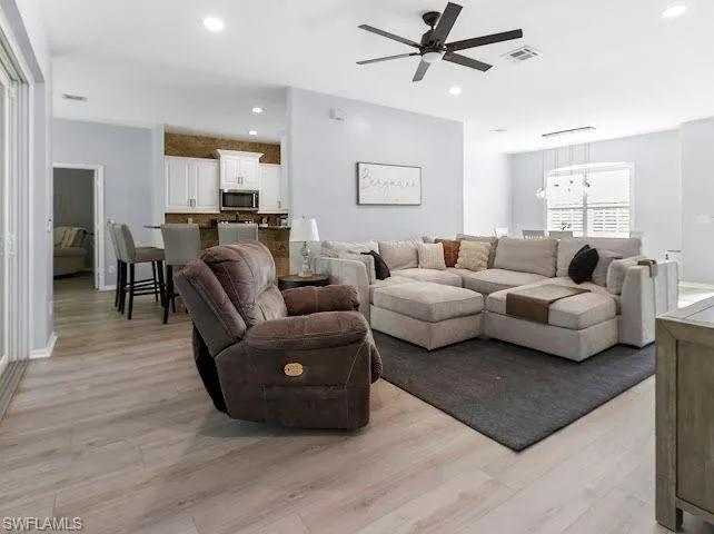 Living area featuring recessed lighting, light wood-style floors, and ceiling fan