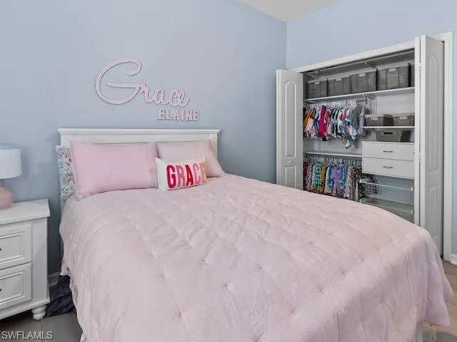 Bedroom featuring a custom closet