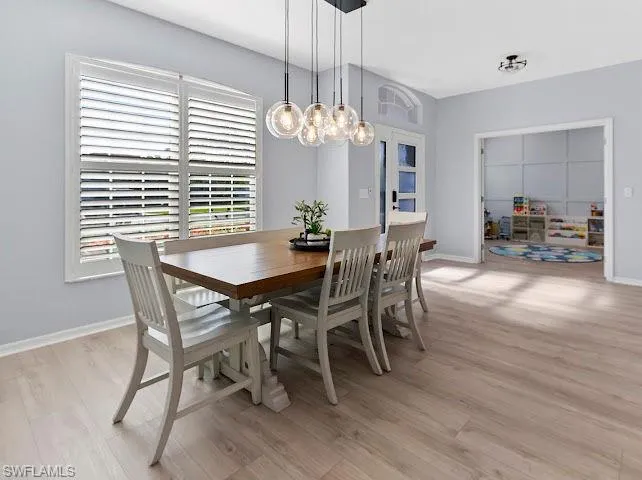 Dining space featuring light wood finished floors and a chandelier