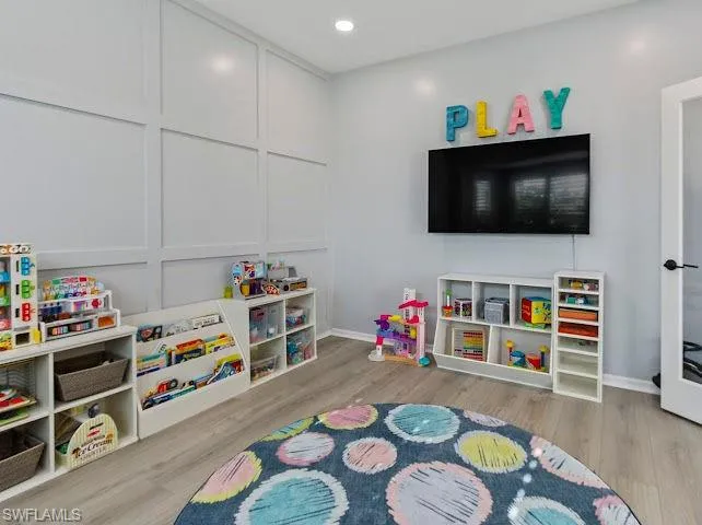 Game room featuring light wood-type flooring and recessed lighting