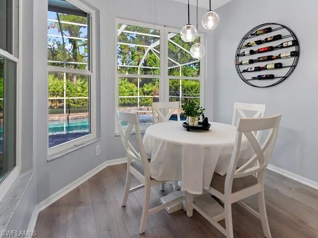 Dining space featuring wood finished floors and baseboards