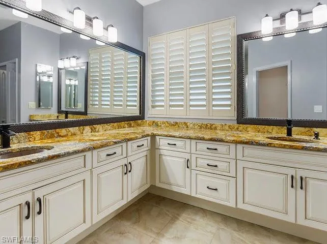 Full bath featuring double vanity