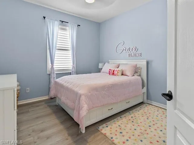 Bedroom with light wood-style floors and a ceiling fan