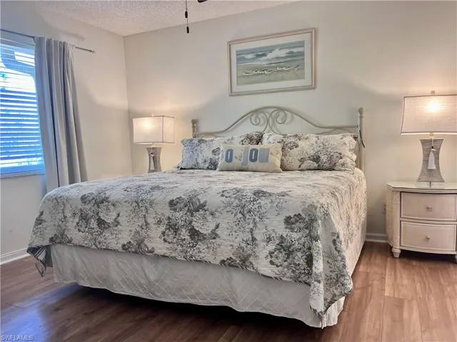 Bedroom featuring a textured ceiling and hardwood / wood-style floors