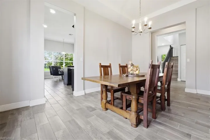 Dining room with suspended lighting and wood finish floors