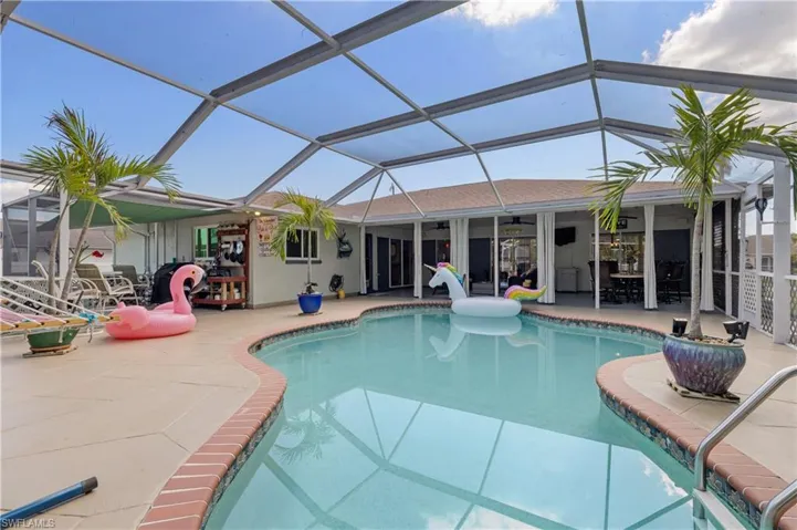 Heated Freeform Pool with Grilling Area in background left