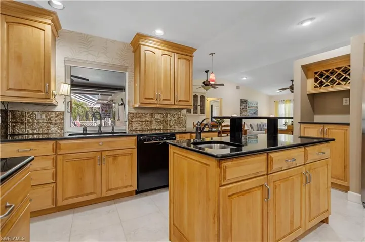 Kitchen with Casual Dining Area and Family Room in background right of center