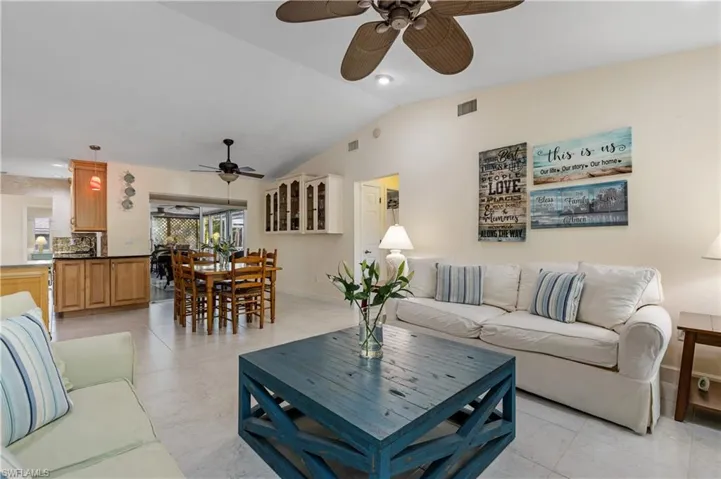 Family Room/Dining Area with Kitchen to left and hallway to guest rooms in center background