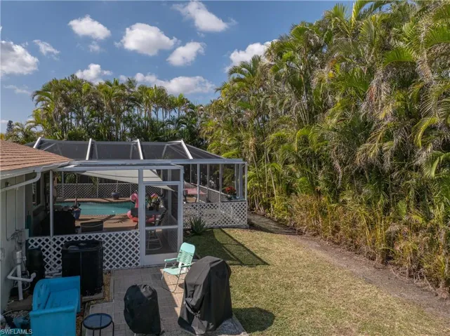 Fenced in backyard with Areca Palms providing privacy