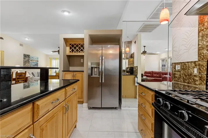 Kitchen with gas cooktop range and Stainless Steel Refrigerator