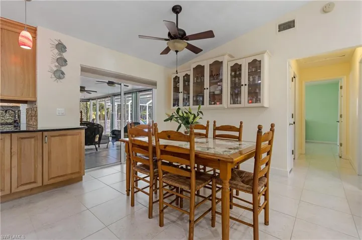 Casual Dining area with sliding doors to lanai and hallway to Guest Bedrooms and Bathroom on right