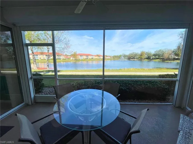 Sunroom / solarium with a water view and a wealth of natural light