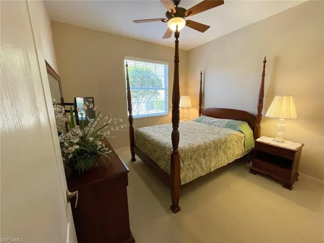 Carpeted bedroom featuring ceiling fan