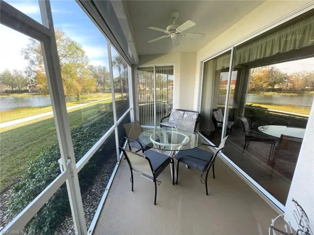 Sunroom featuring ceiling fan, a healthy amount of sunlight, and a water view