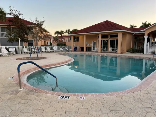 Pool at dusk featuring a patio area