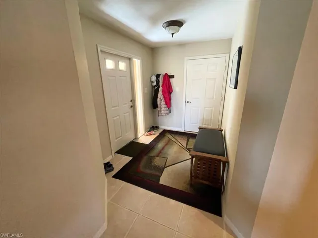 Foyer with light tile patterned floors