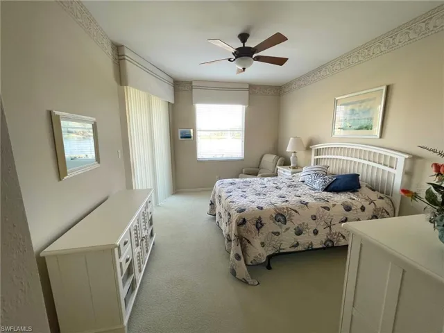Bedroom featuring light carpet and ceiling fan