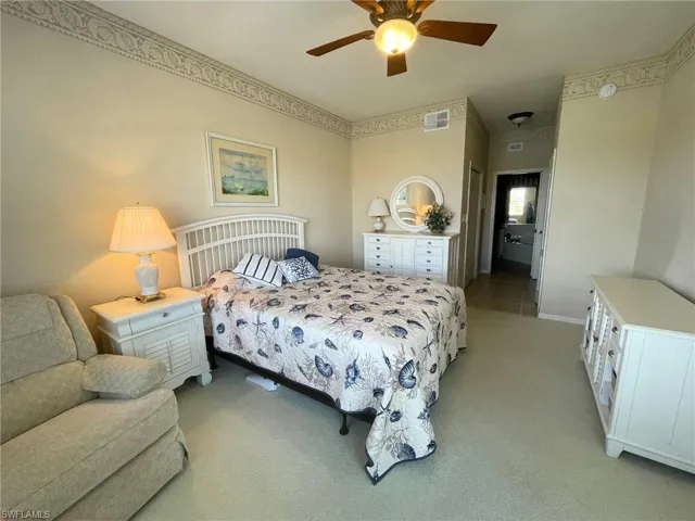 Bedroom featuring light colored carpet and ceiling fan
