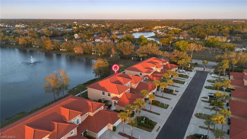 Aerial view at dusk featuring a water view