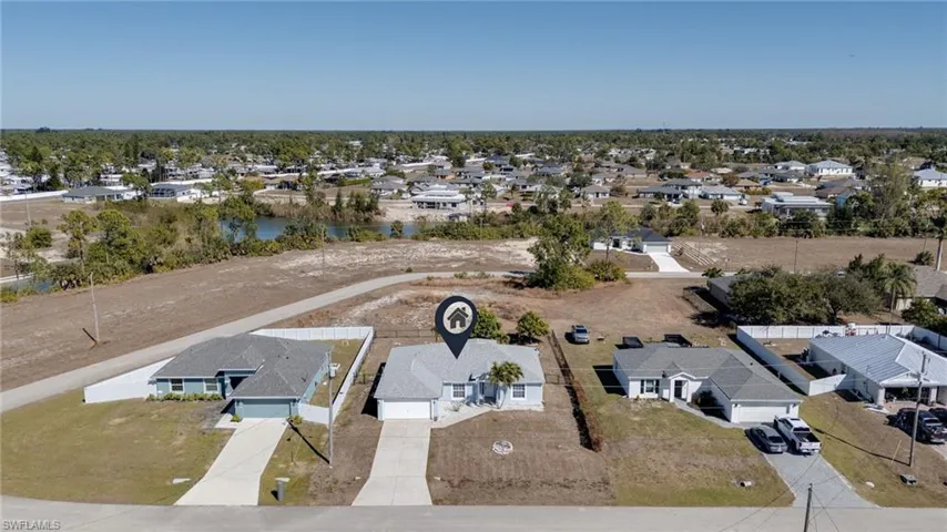 Aerial perspective of suburban area featuring a large body of water