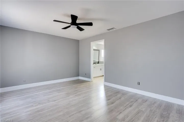Spare room featuring ceiling fan and light wood-type flooring