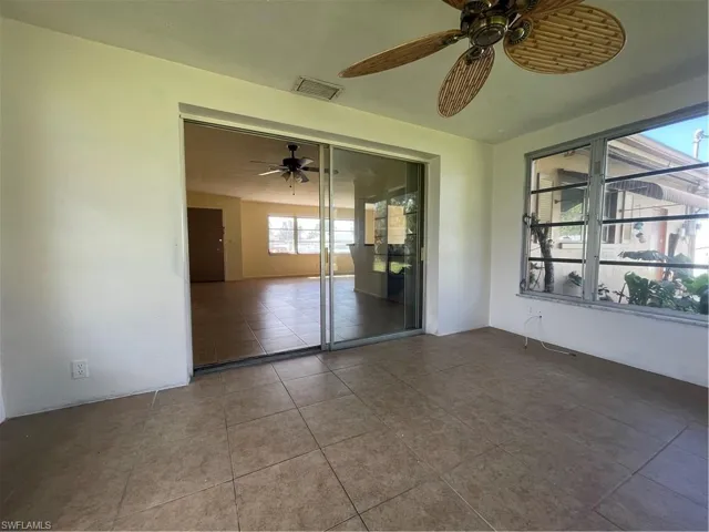 Unfurnished bedroom with a closet, ceiling fan, and tile patterned floors