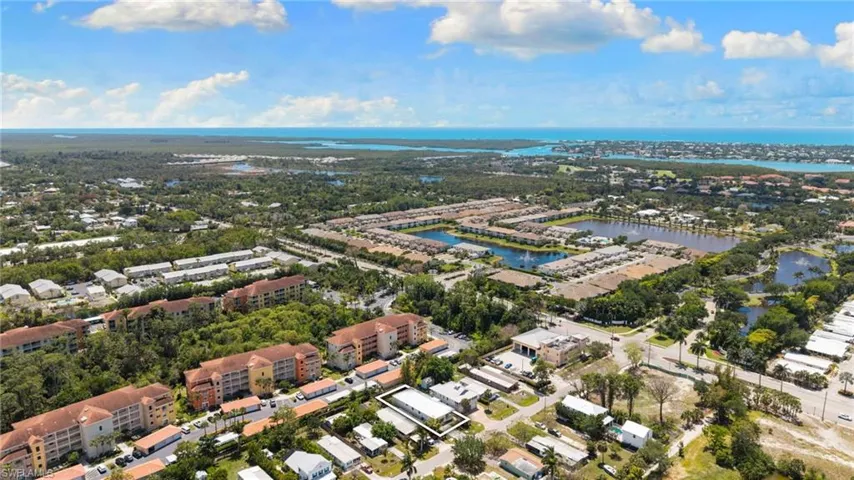 Aerial view showcasing a coastal community with extensive waterways and diverse residential structures