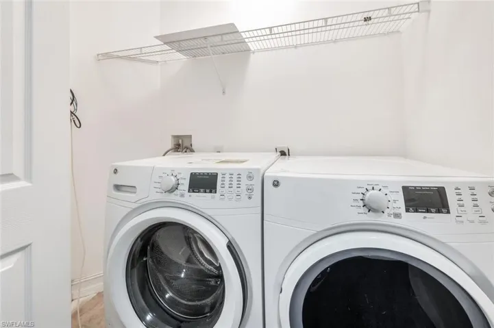 Laundry area featuring washer and dryer and tile patterned floors