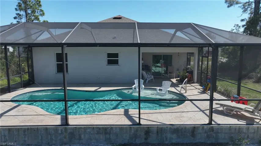 View of pool with a patio and a lanai