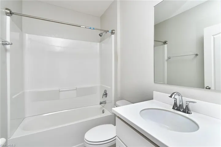 Full bathroom featuring vanity, toilet, and shower / bathtub combination