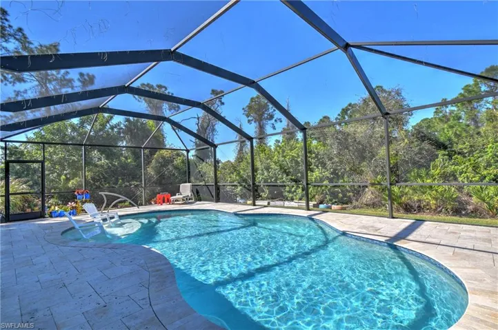 View of swimming pool featuring a lanai and a patio