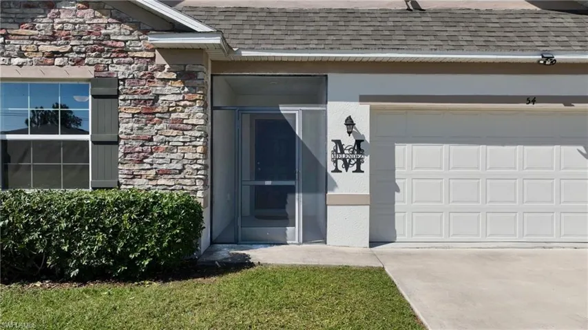 Entrance to property with a garage