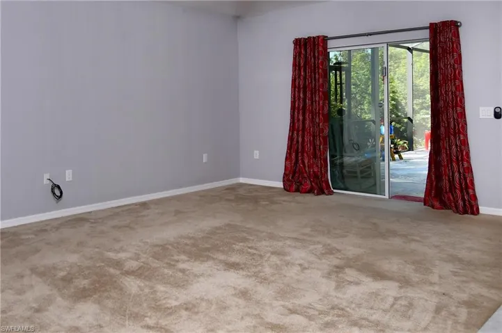 Empty room featuring light colored carpet