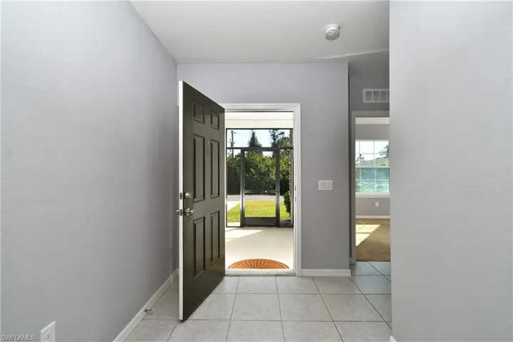 Entryway featuring light tile patterned floors