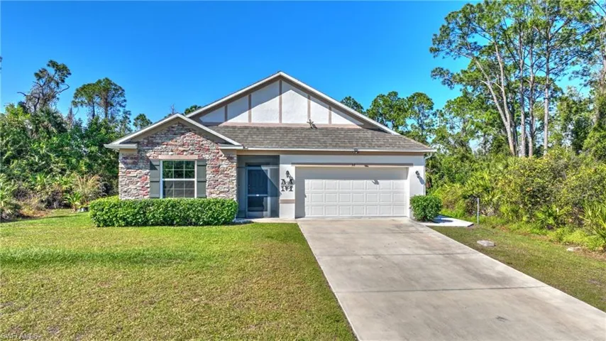 View of front of house with a front lawn and a garage